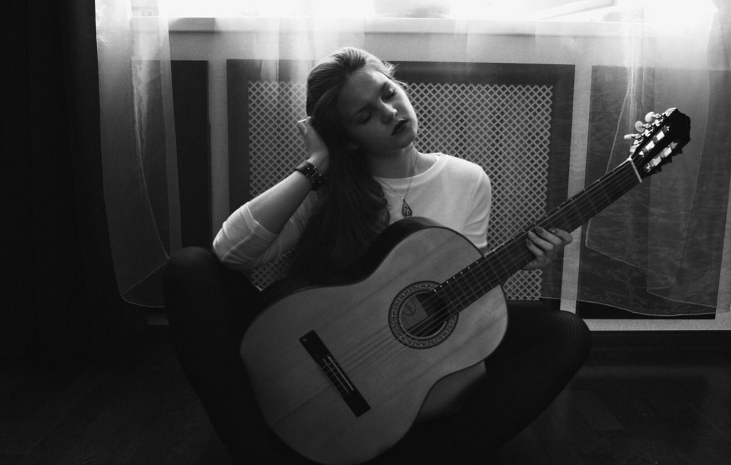 girl guitar holding head, neck pain headaches